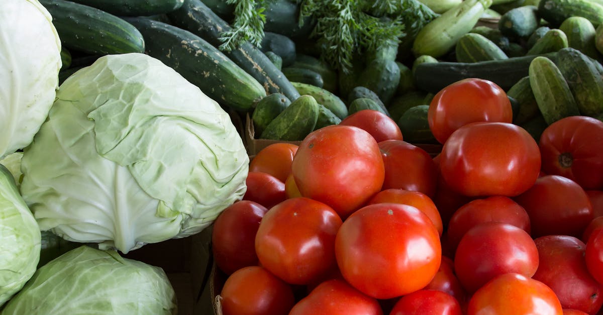 Vibrant display of organic vegetables including tomatoes, cabbages, and more at a North Carolina market.